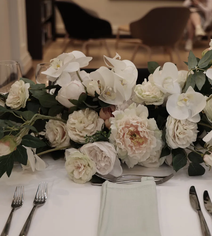 White roses and peonies on a set event table